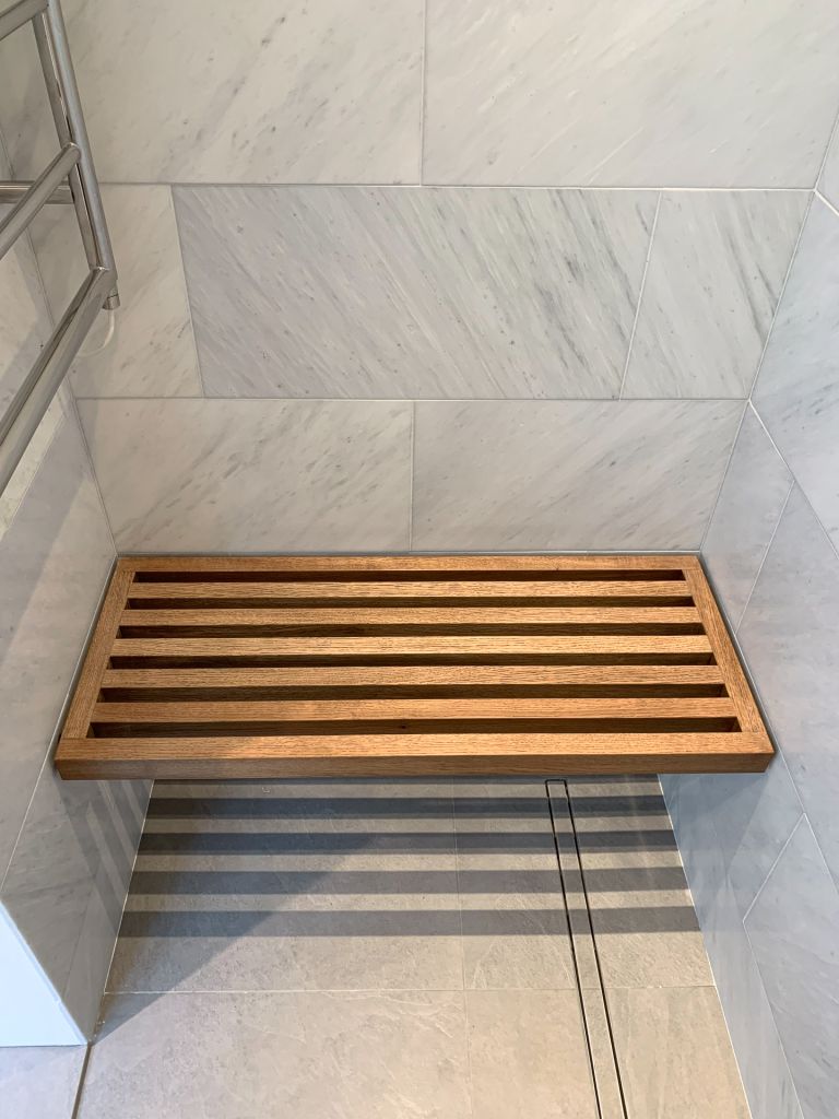 dark stained slatted oak floating shower seat