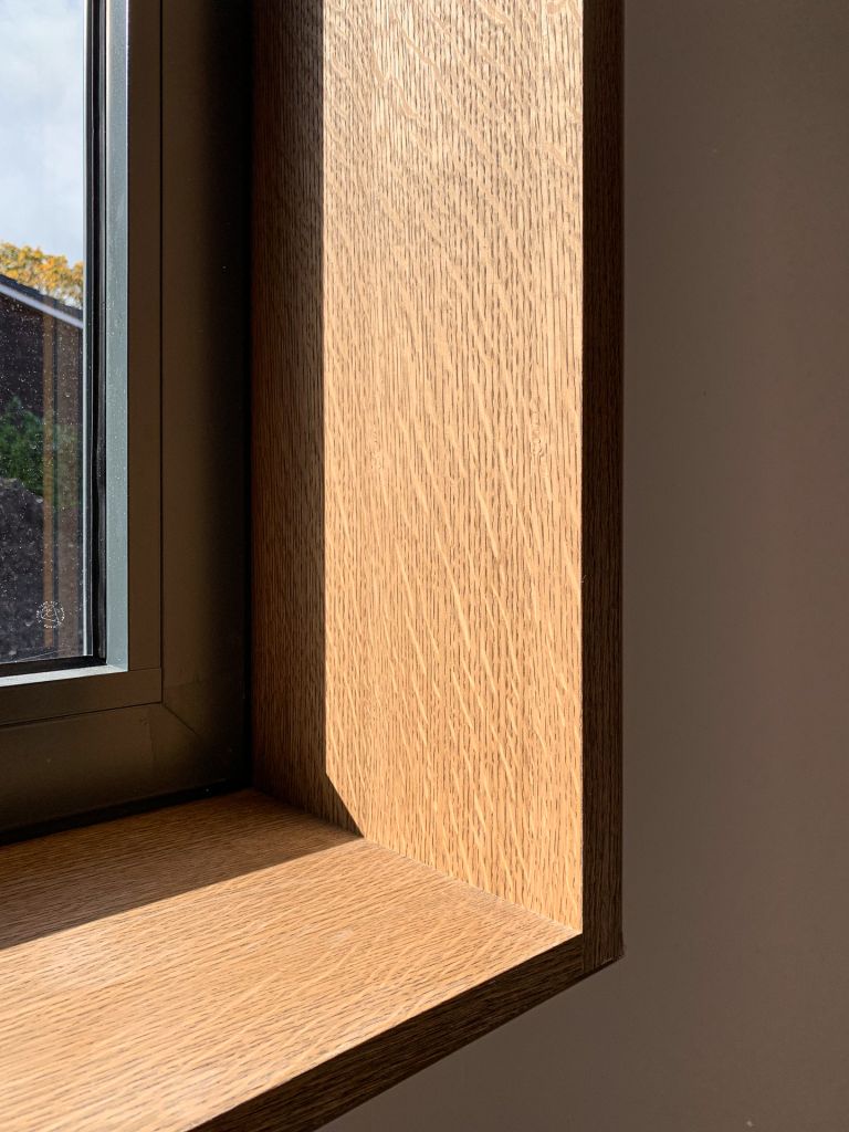 timber window reveal in dark stained oak